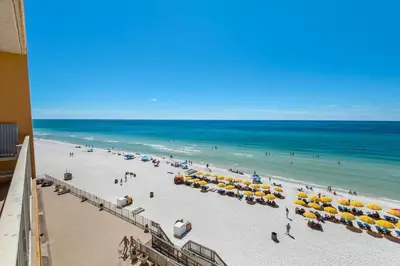 a view of a beach with umbrellas and the ocean at Treasure Island 0505 in Panama City Beach
