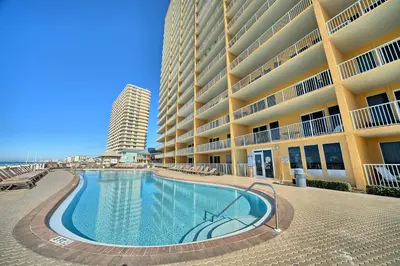 a swimming pool in front of a large building at Treasure Island 0505 in Panama City Beach