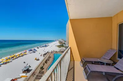 a balcony with a view of a beach and the ocean at Treasure Island 0505 in Panama City Beach