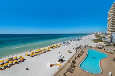 an aerial view of a beach with umbrellas and the ocean at Treasure Island 0505 in Panama City Beach