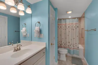 a bathroom with a sink and a toilet and a shower at Treasure Island 1611 in Panama City Beach