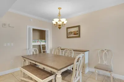 a dining room with a wooden table and chairs at Treasure Island 1611 in Panama City Beach