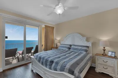 a bedroom with a bed with a view of the ocean at Treasure Island 1611 in Panama City Beach