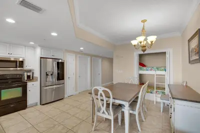 a kitchen with a table and chairs and a dining room at Treasure Island 1611 in Panama City Beach