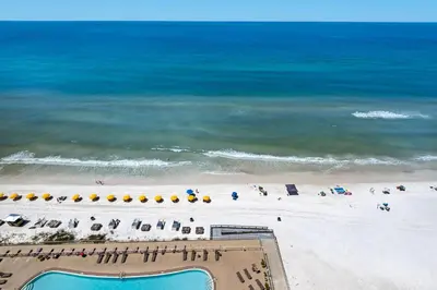 an overhead view of a beach with chairs and umbrellas at Treasure Island 1612 in Panama City Beach