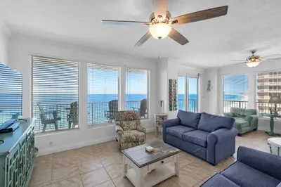 a living room with a couch and a ceiling fan at Treasure Island 1612 in Panama City Beach
