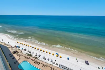 an overhead view of a beach with umbrellas and the ocean at Treasure Island 1612 in Panama City Beach