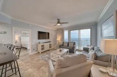 a living room with a view of the ocean at Treasure Island 1706 in Panama City Beach