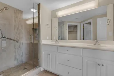 a bathroom with two sinks and a shower at Treasure Island 1911 in Panama City Beach