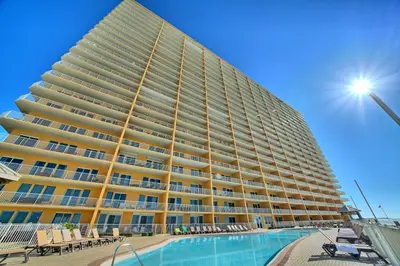 a large building with a pool in front of it at Treasure Island 1911 in Panama City Beach