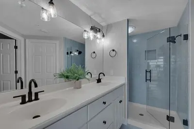 a bathroom with a sink and a glass shower at Treasure Island 0802 in Panama City Beach