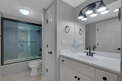 a white bathroom with a sink and a toilet at Treasure Island 0802 in Panama City Beach