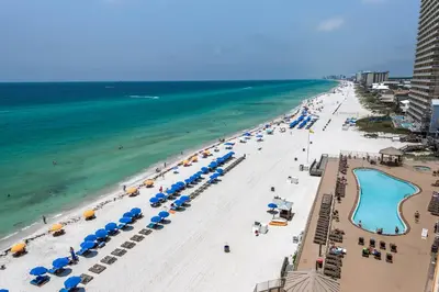 an aerial view of a beach with umbrellas and the ocean at Treasure Island 0802 in Panama City Beach