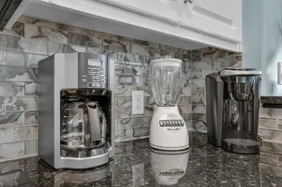 a kitchen counter with a blender and a coffee maker at Treasure Island 1904 in Panama City Beach