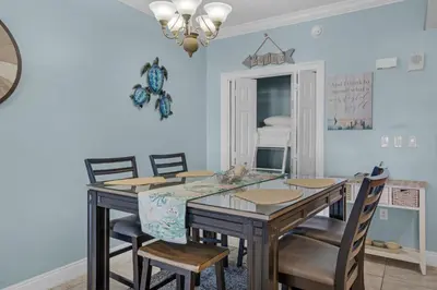 a dining room with a table and chairs at Treasure Island 1904 in Panama City Beach
