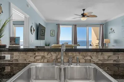 a kitchen sink with a view of the ocean at Treasure Island 1904 in Panama City Beach