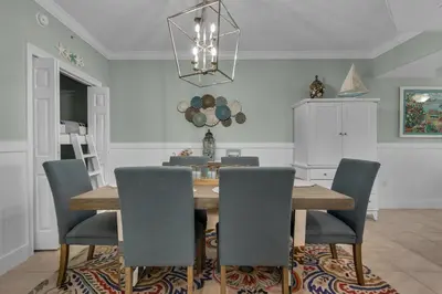 a dining room with a wooden table and chairs at Treasure Island 0805 in Panama City Beach