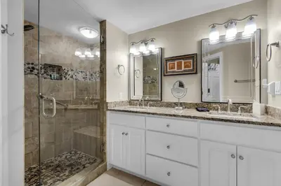 a bathroom with two sinks and a shower at Treasure Island 0805 in Panama City Beach