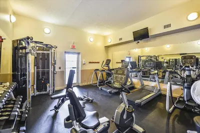 a gym with several treadmills and exercise bikes at Treasure Island 0805 in Panama City Beach