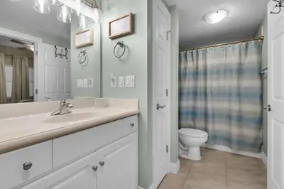 a white bathroom with a sink and a toilet at Treasure Island 0805 in Panama City Beach