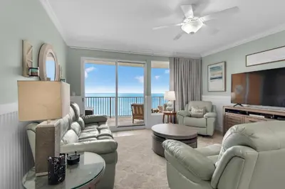 a living room with a couch and a television at Treasure Island 0805 in Panama City Beach