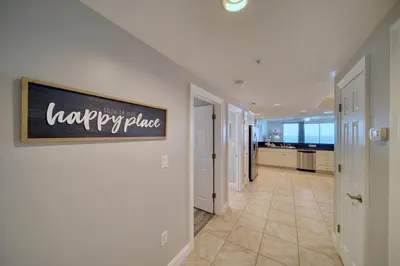 a hallway of a house with a sign on the wall at Treasure Island 1510 in Panama City Beach