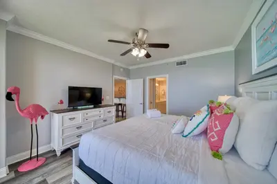 a bedroom with a bed with a pink flamingo in it at Treasure Island 1510 in Panama City Beach