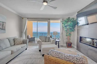a living room with a couch and a fireplace at Treasure Island 1811 in Panama City Beach