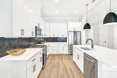 a white kitchen with white cabinets and a sink at New-Walk To Beach - Private Heated Pool in Inlet Beach