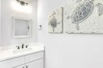 a white bathroom with a sink and a mirror at New-Walk To Beach - Private Heated Pool in Inlet Beach