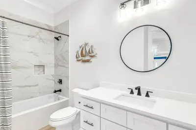 a white bathroom with a sink and a mirror at New-Walk To Beach - Private Heated Pool in Inlet Beach