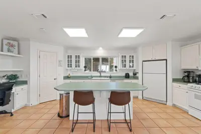 a kitchen with a table and two chairs in it at Spacious 3-Story Bayfront Home Perfect for Family Fun & Relaxation in Panama City