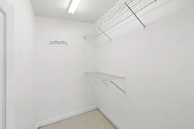 an empty room with white walls and a staircase at Spacious 3-Story Bayfront Home Perfect for Family Fun & Relaxation in Panama City