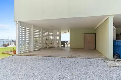 an empty building with a patio with a view of the ocean at Spacious 3-Story Bayfront Home Perfect for Family Fun & Relaxation in Panama City