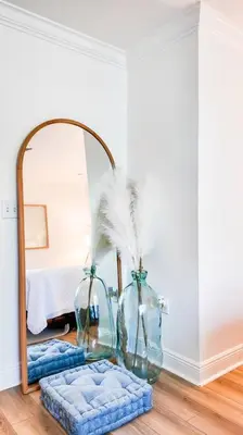 a mirror in a room with two vases and a table at Walk to Rosemary - Poolside, 6 Bikes, Beach Access in Inlet Beach