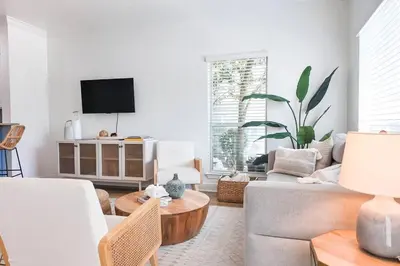 a living room with a couch and a table at Walk to Rosemary - Poolside, 6 Bikes, Beach Access in Inlet Beach