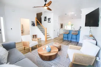 a living room with a couch and a table at Walk to Rosemary - Poolside, 6 Bikes, Beach Access in Inlet Beach