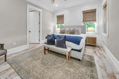 a bedroom with a bed with pillows on it at Town of Prominence- Just Beachy in Inlet Beach