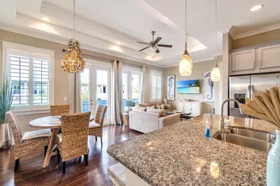 a kitchen and living room with a table and chairs at Ta-Da! Luxury 2BR Townhome, Golf Cart & Pool Access in Santa Rosa Beach