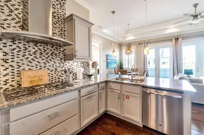 a kitchen with white cabinets and a stove at Ta-Da! Luxury 2BR Townhome, Golf Cart & Pool Access in Santa Rosa Beach