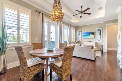 a dining room with a table and chairs and a couch at Ta-Da! Luxury 2BR Townhome, Golf Cart & Pool Access in Santa Rosa Beach