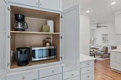 a kitchen with white cabinets and a microwave at Steps to Public & Private Beach in Seacrest FL 30A, Pool, Bikes, Gear, and More! in Seacrest