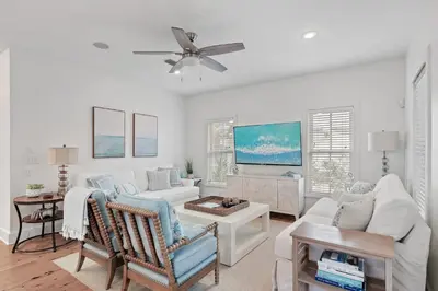 a living room with white furniture and a ceiling fan at Steps to Public & Private Beach in Seacrest FL 30A, Pool, Bikes, Gear, and More! in Seacrest