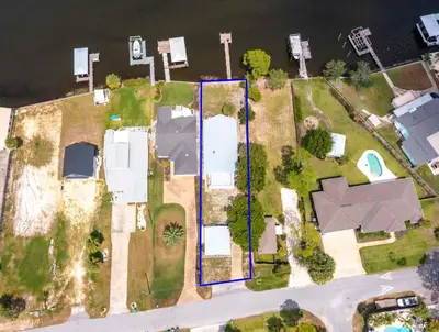 an aerial view of a house next to the water at Dolphin Days Lagoon Retreat in Panama City Beach
