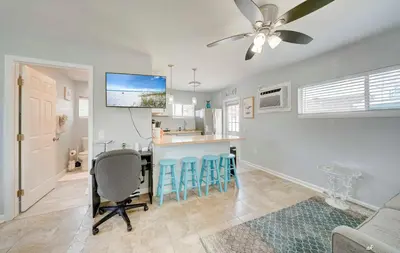 a kitchen and living room with a table and chairs at Dolphin Days Lagoon Retreat in Panama City Beach