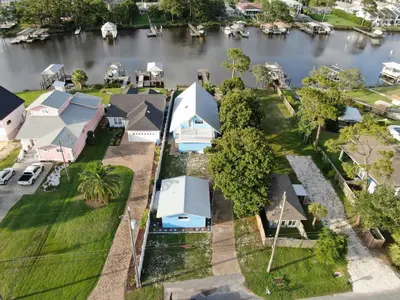 an aerial view of a row of houses next to a river at Dolphin Days Lagoon Retreat in Panama City Beach