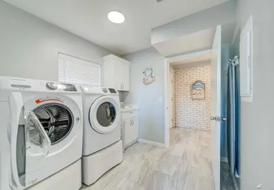 a laundry room with a washer and dryer at Dolphin Days Lagoon Retreat in Panama City Beach