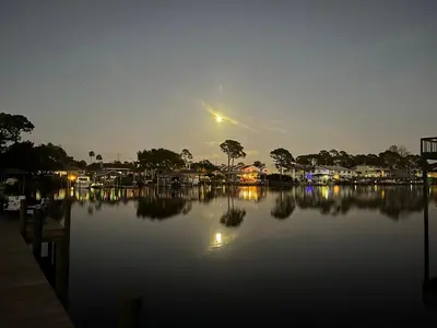 a view of a body of water at night at Dolphin Days Lagoon Retreat in Panama City Beach