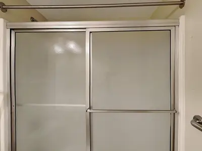 a sliding glass shower door in a bathroom at Majestic Beach Towers I #2302 in Panama City Beach