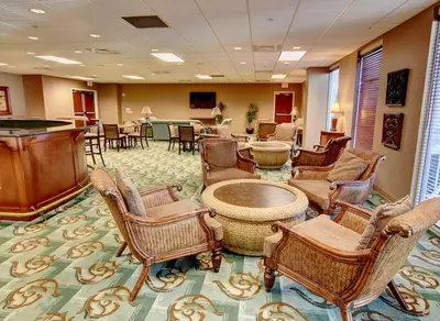 a waiting room with chairs and a table at Majestic Beach Towers I #2302 in Panama City Beach